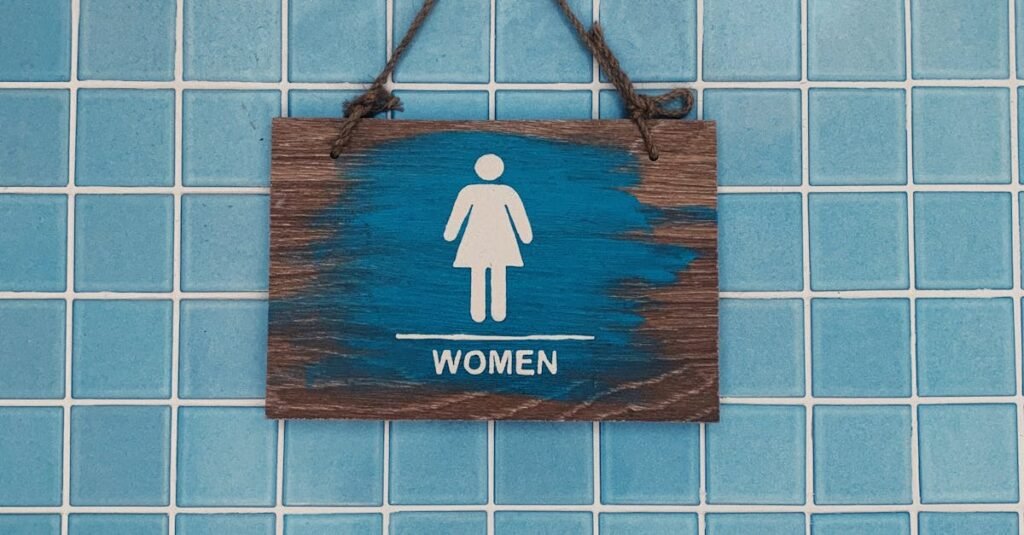 Wooden Signage Hanging on Blue Tiled Wall