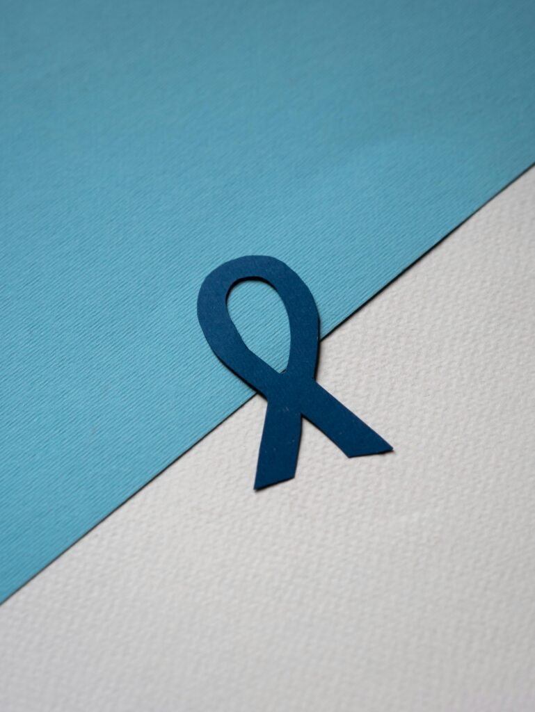 Blue awareness ribbon on two-toned textured background conveying support and solidarity.