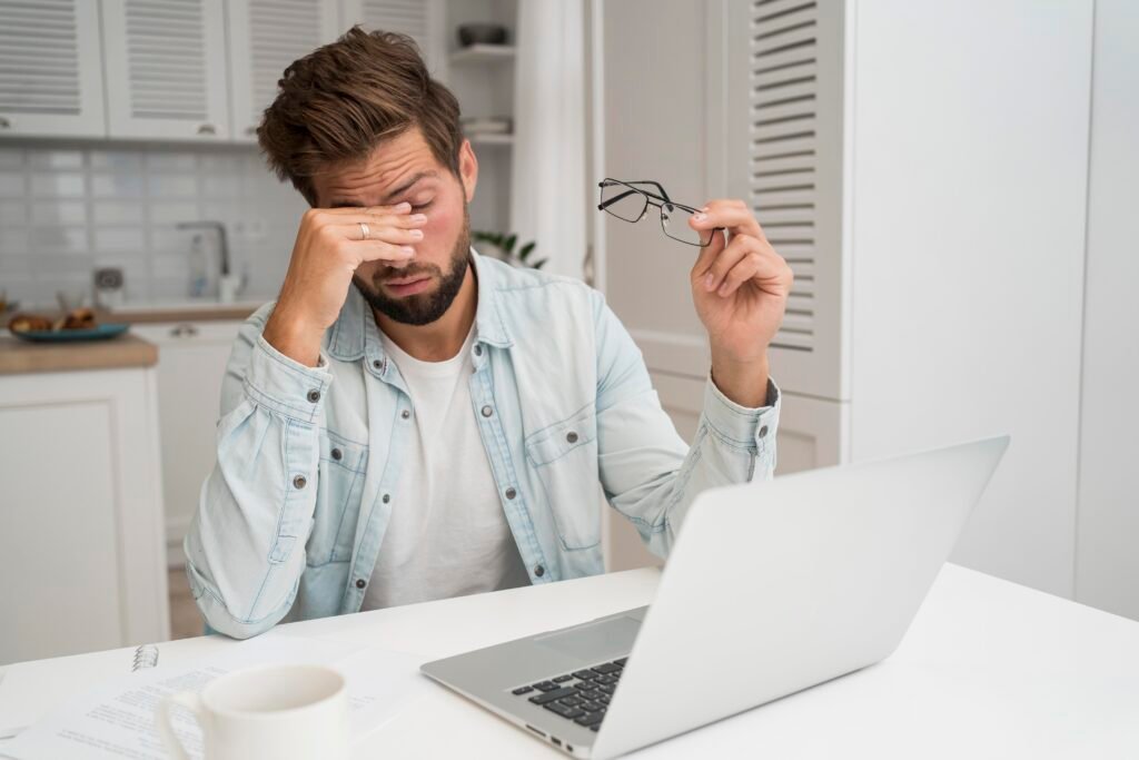 casual-adult-male-working-from-home with eye strain